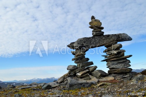 Bild på Stone cairn stone man trailmark construction on top of a mountain in subarctic Swedish Lapland
